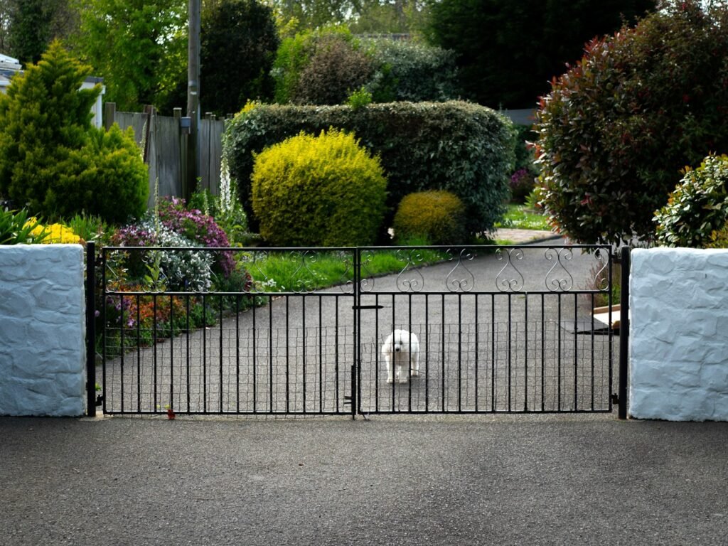 Ornate metal swing gate at a property entrance