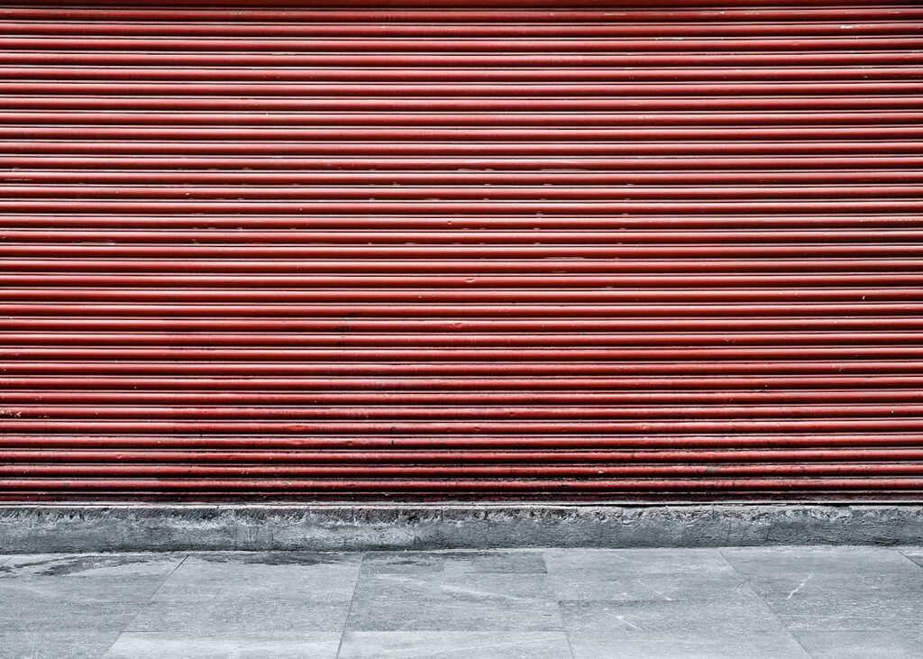 Row of metal roller shutters on retail units